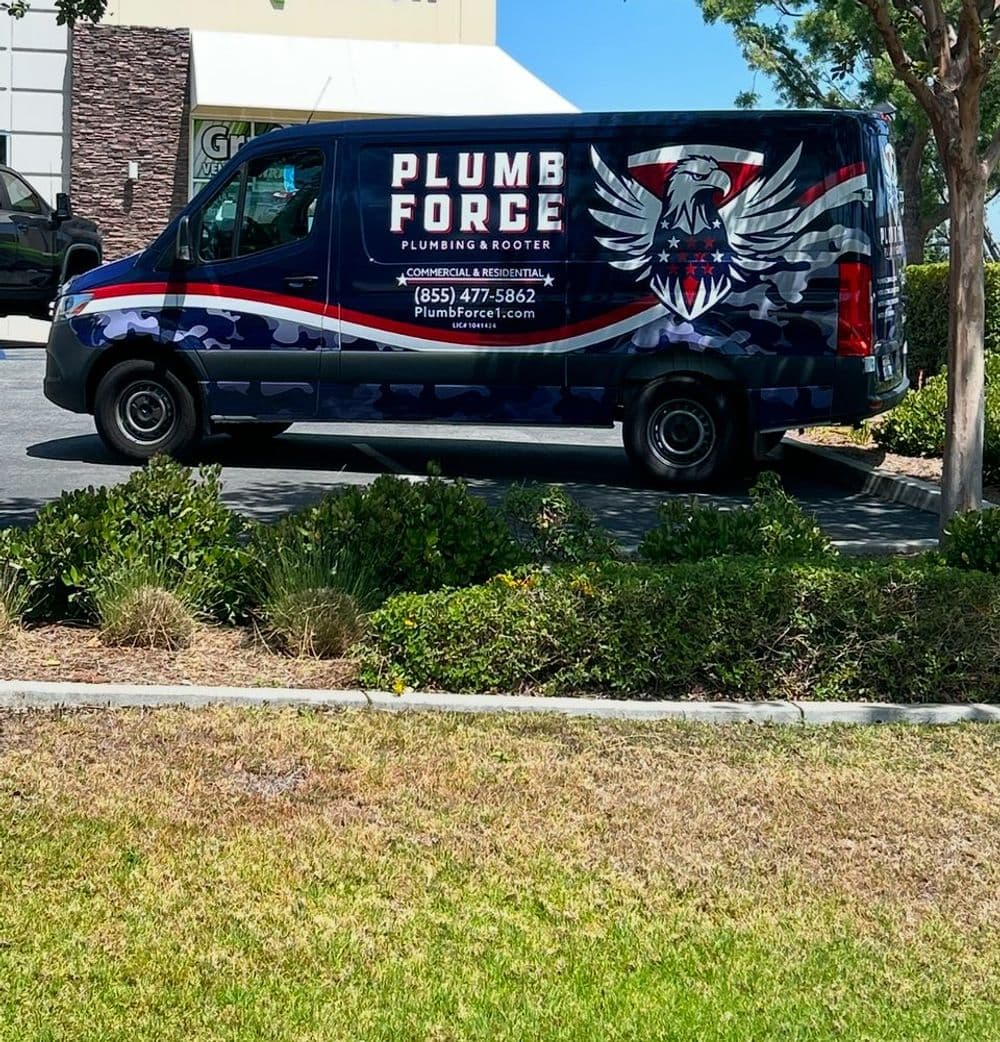Plumb Force plumbing van with eagle logo parked outside a business. Contact: 855-477-5824.